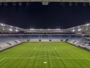 A soccer stadium by night, highly illuminated