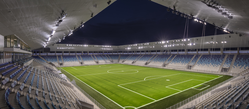 A soccer stadium at night, highly illuminated