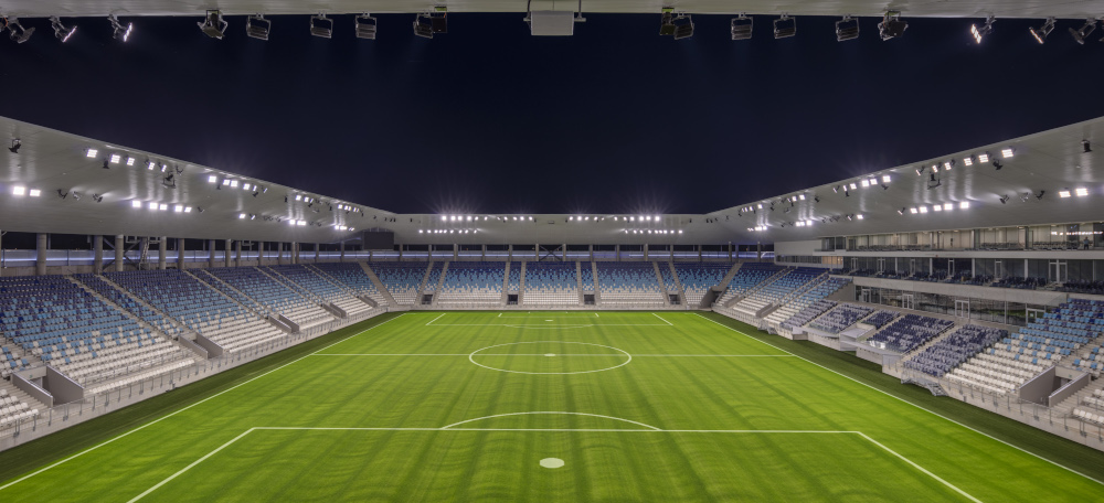A soccer stadium by night, highly illuminated