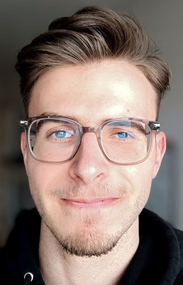 Portrait photo of a young man with glasses