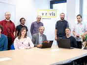 The researchers of the GeoSMAQ Group in front of the VRVis banner.