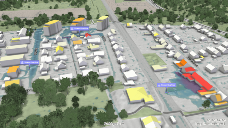 Screenshot aus Visdom, das eine Siedlung mit farblich gekennzeichneten Häusern mit verschiedenem Hochwasserrisiko und Überschwemmungszonen zeigt. 