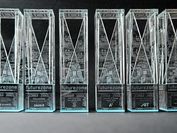 Six award sculptures made of glass side by side